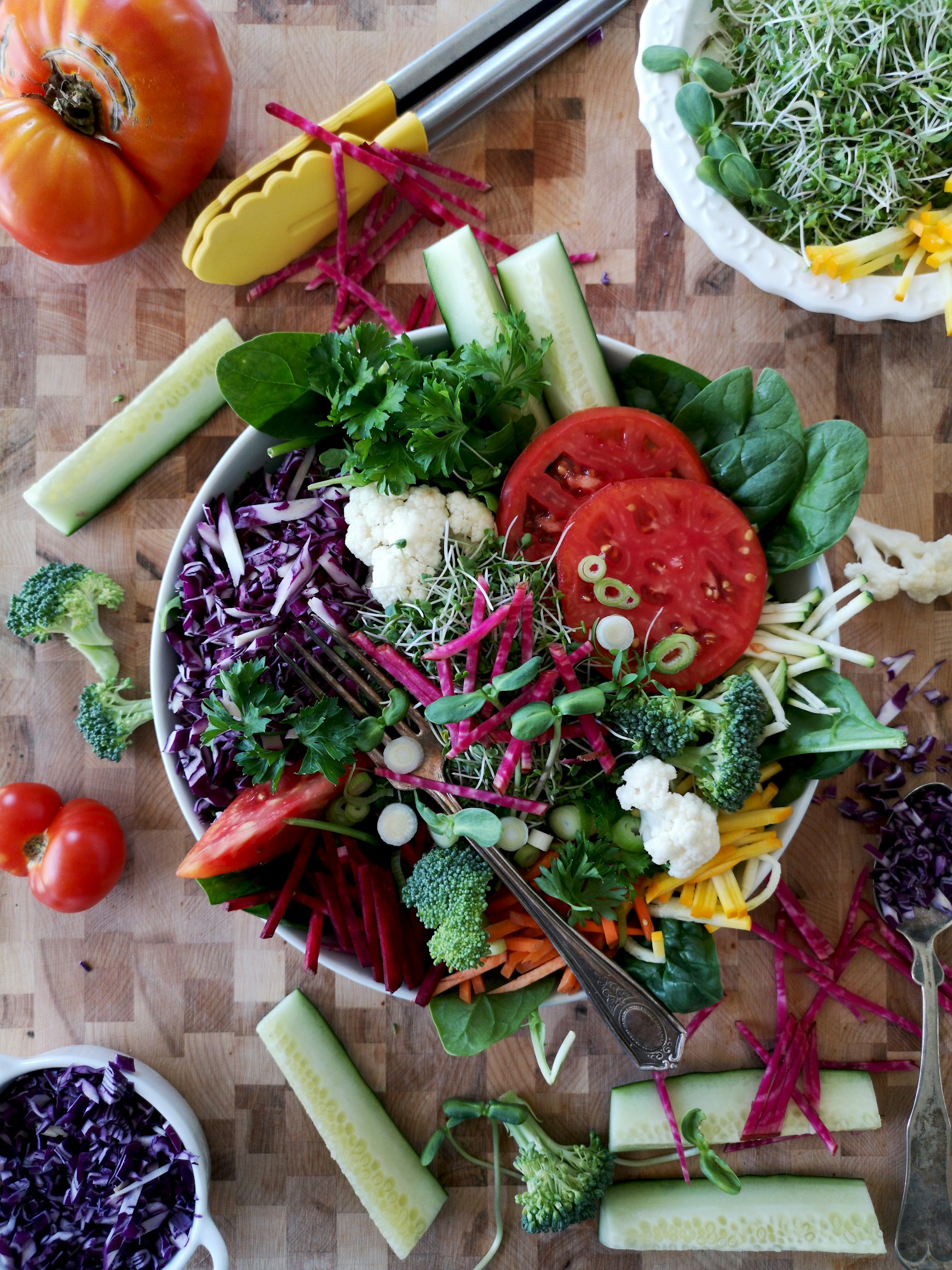 A fresh garden salad with tomatoes, cucumber and leafy greens, ready to share